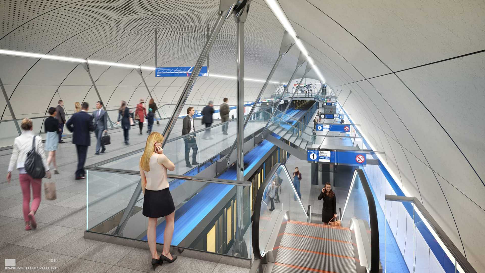 Vizualizace stanice Pankrác na metru D při pohledu z lávky vedoucí nad nástupištěm: klenutý perforovaný strop na štíhlých ocelových vzpěrách, cestující na lávce i na nástupišti pod ní, vpravo klesající eskalátory a u hrany nástupiště stojící souprava.